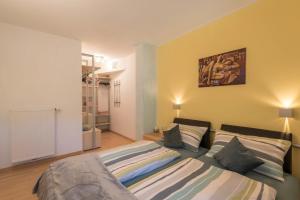 a bedroom with two beds and a painting on the wall at Apartment Schlernblick in Umes