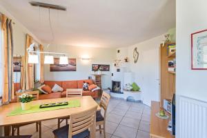 a kitchen and living room with a table and a couch at Apartment Schlernblick in Umes +28 photos