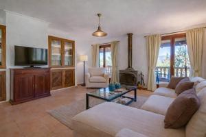a living room with a couch and a fireplace at Son Grau in Alaró