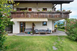 a house with a balcony with a table and chairs at Harmony room in Piano +23 photos