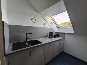 a kitchen with a sink and a window at Ferienwohnung Andreas in St. Blasien +15 photos