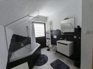 a bathroom with a tub and a toilet and a sink at Ferienwohnung Andreas in St. Blasien