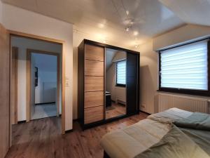 a bedroom with a bed and a large mirror at Ferienwohnung Andreas in St. Blasien