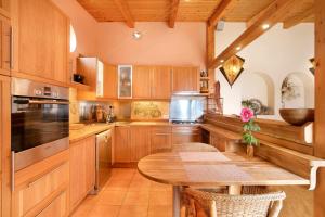 a kitchen with wooden cabinets and a wooden table at Casa Anakena in Guía de Isora