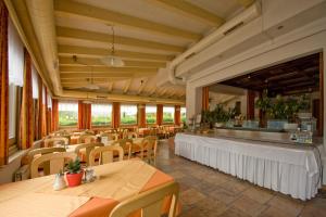 a restaurant with tables and chairs and a bar at Hotel Hohe Tauern in Matrei in Osttirol
