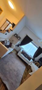 an overhead view of a living room with white furniture at La Locanda dei Nonni in Pozza di Fassa +11 photos