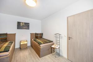 a bedroom with a bed and a ladder next to a door at Radlerrast in Weißenfels