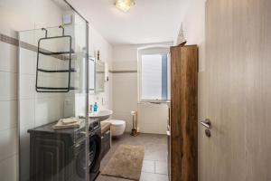 a small bathroom with a sink and a washing machine at Radlerrast in Weißenfels +12 photos