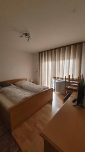 a bedroom with a large bed in front of a window at Fe-Wo Berg und See in Hauzenberg