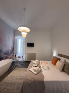 a bedroom with a large bed and a bath tub at Dimora Perrini in Fasano