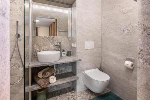 a bathroom with a toilet and a sink and a mirror at Pixnerhof - Ferienwohnung Gala in Kastelbell-Tschars +22 photos