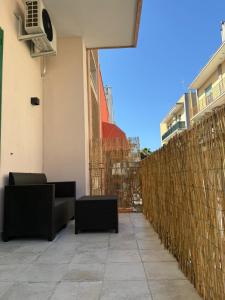 a patio with two couches and a fence at Dimora Perrini in Fasano