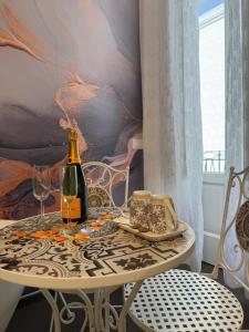a table with a bottle of wine and a glass at Dimora Perrini in Fasano
