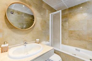a bathroom with a sink and a toilet and a mirror at El Hacho in Manilva +21 photos