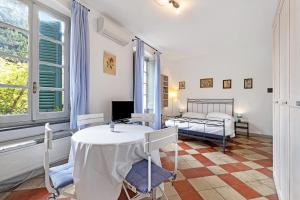 a bedroom with a table and a bed in a room at Monolocale Isotta in Finale Ligure