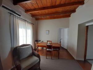 a living room with a table and a couch at De Kothuize 16 in Graaff-Reinet