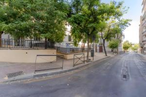 an empty street with trees on the side of the road at Camarón Suite in Granada