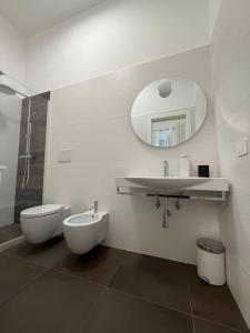 a bathroom with a sink and a toilet and a mirror at Dimora Perrini in Fasano +25 photos
