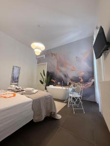 a bedroom with a large bed and a bath tub at Dimora Perrini in Fasano