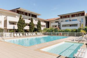 a swimming pool in front of a building at Appartement - Terrasses De L'Océan in Moliets-et-Maa