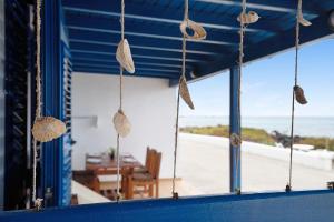 a room with a window with a view of the beach at Punta Marea in Punta Mujeres +14 photos