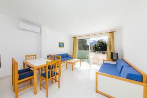 a living room with a table and chairs and a dining room at Apartament Massanet bc in Canyamel