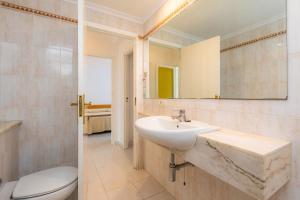 a bathroom with a sink and a toilet and a mirror at Apartament Massanet bc in Canyamel +17 photos