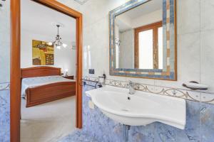 a bathroom with a sink and a bed at La Pineta in SantʼAntìoco +44 photos