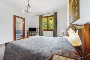a bedroom with a large bed with a wooden headboard at La Pineta in SantʼAntìoco
