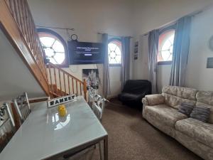 a living room with a couch and a table at Ramsgate Sea-side Stay! in Ramsgate
