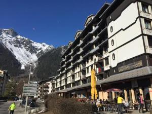 a building on a street with a mountain in the background at Amanuq lovely apartment in Chamonix