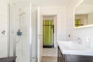 a bathroom with a sink and a shower at Ferienwohnung Rothmund in Überlingen