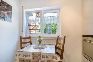 a small kitchen with a table and a window at Ferienwohnung Rothmund in Überlingen +14 photos