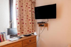 a flat screen tv on a wall next to a window at Amanuq lovely apartment in Chamonix