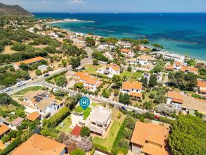 an aerial view of a suburb with houses and the ocean at Nuràya in Sarroch