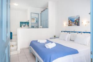 a bedroom with a large bed with a blue blanket at Pico Bello Patmos 14 in Patmos