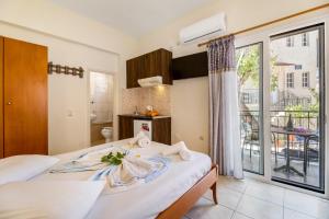 a bedroom with a bed and a large window at Nikiana Club - Studio 6 in Nikiana