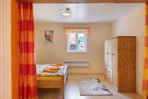 a small bedroom with a bed and a window at Ferienwohnung im alten Vierseithof in Friedewald