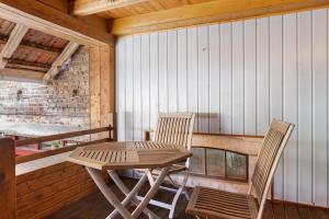 two chairs and a table on the porch of a cabin at Ferienwohnung im alten Vierseithof in Friedewald