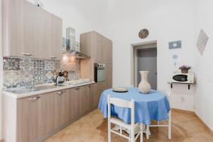 a kitchen with a table with a blue table cloth on it at Casa Petros in Marsala