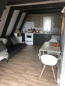 a kitchen with a couch and a table in a room at Chalet Le Pointu - St-Lawrence River View in Rivière-du-Loup +9 photos