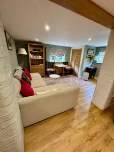 a living room with a couch and a table at The Grannery in Wadhurst