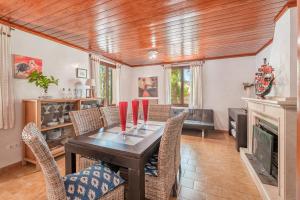 a dining room with a table and chairs and a fireplace at Villa Ses Basses in Mancor del Valle