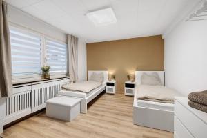 a room with two beds and a window at Haus Flora Bianca in Albstadt