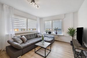 a living room with a couch and a table at Haus Flora Bianca in Albstadt