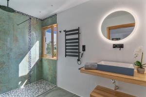 a bathroom with a shower with a sink and a mirror at El Alcaidón in Tías +49 photos