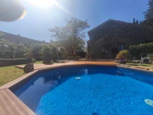 a swimming pool in front of a house at Maison d'hôte Mas de Castille entre Uzès et le pont du Gard in Argilliers