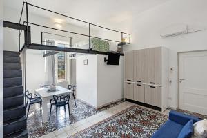 a living room with a loft bed and a table at Le Suite del Castello in Castellammare di Stabia