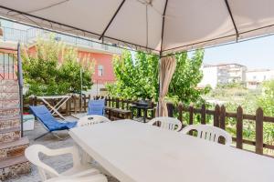 a white table and chairs on a patio at Sea Nest in Balestrate