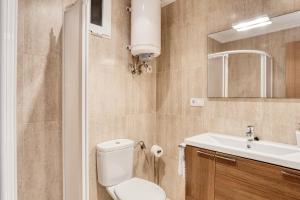 a bathroom with a toilet and a sink at Sunflower Puerto Rico in Santa Pola +17 photos